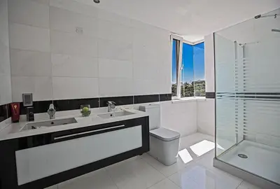 a bathroom with a sink and a toilet and a shower at Villa Saranta Gold - Exquisite 3 Bedroom Protaras Villa With Private Pool in Protaras
