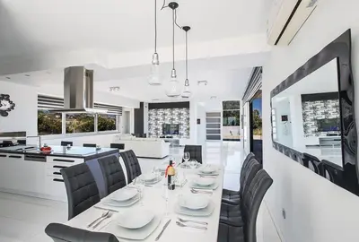 a dining room and kitchen with a table and chairs at Villa Saranta Gold - Exquisite 3 Bedroom Protaras Villa With Private Pool in Protaras
