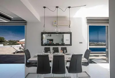 a dining room with a table and chairs at Villa Saranta Gold - Exquisite 3 Bedroom Protaras Villa With Private Pool in Protaras