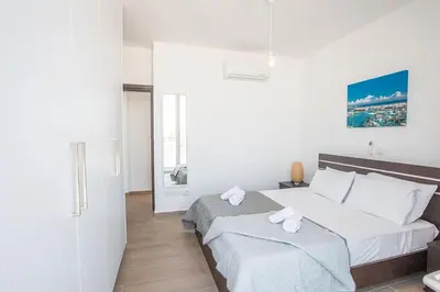 a bedroom with a large bed with two white pillows at Villa Olive Titan, Brand New,Exquisite 5Bdr Protaras Villa With Pool in Protaras