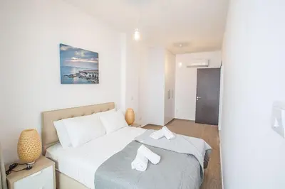 a bedroom with a bed with two white towels on it at Villa Olive Titan, Brand New,Exquisite 5Bdr Protaras Villa With Pool in Protaras