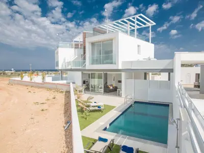 a house on the beach with a swimming pool at Villa Olive Bronze, Luxurious 2Bdr With Pool, Close To Protaras Strip And Beach in Protaras