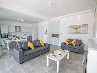 a living room with two couches and a table at Villa Olive Bronze, Luxurious 2Bdr With Pool, Close To Protaras Strip And Beach in Protaras