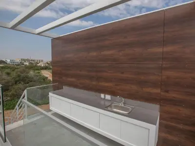 a large wooden wall in a room with a sink at Villa Olive Bronze, Luxurious 2Bdr With Pool, Close To Protaras Strip And Beach in Protaras