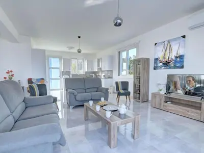 a living room with two couches and a tv at Villa Kono Provoles - Luxury 4 Bedroom Protaras Villa With Stunning Panoramic in Protaras