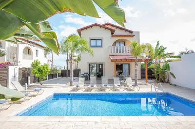 a villa with a swimming pool and a house at Villa Kanthos - Beautiful 4 Bedroom Protaras Villa With Pool in Protaras