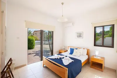 a bedroom with a bed with towels on it at Villa Kanthos - Beautiful 4 Bedroom Protaras Villa With Pool in Protaras