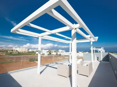 a white pergola on the roof of a house at Villa Panemorfi - Luxury Brand New 3 Bedroom Protaras Villa With Private Pool in Protaras