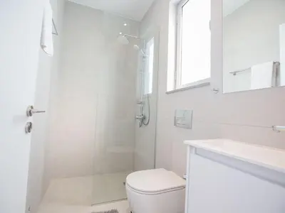 a bathroom with a shower and a toilet and a sink at Villa Panemorfi - Luxury Brand New 3 Bedroom Protaras Villa With Private Pool in Protaras