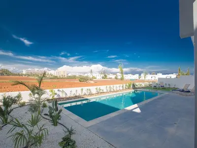 a swimming pool in front of a building at Villa Panemorfi - Luxury Brand New 3 Bedroom Protaras Villa With Private Pool in Protaras
