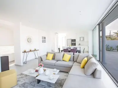 a living room with a couch and a table at Villa Panemorfi - Luxury Brand New 3 Bedroom Protaras Villa With Private Pool in Protaras