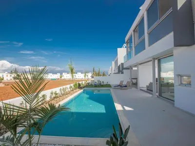 a swimming pool in the backyard of a house at Villa Panemorfi - Luxury Brand New 3 Bedroom Protaras Villa With Private Pool in Protaras