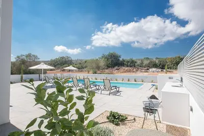 a swimming pool with a bunch of chairs next to it at Villa Ochosto Loux - Fabulous 5 Bedroom Protaras Villa With Private Pool in Protaras