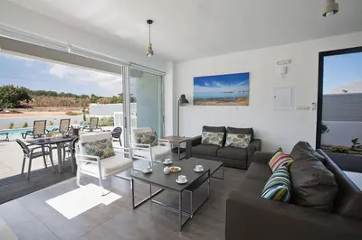 a living room with a couch and a table at Villa Ochosto Loux - Fabulous 5 Bedroom Protaras Villa With Private Pool in Protaras