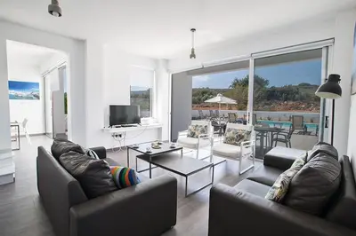 a living room with couches and a television and a table at Villa Ochosto Loux - Fabulous 5 Bedroom Protaras Villa With Private Pool in Protaras