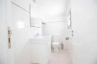 a white bathroom with a sink and a toilet at Villa Protara Chrysos - Beautiful 5 Bedroom Protaras Villa - Walking Distance in Protaras