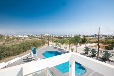 a view from the balcony of a house with two swimming pools at Villa Protara Chrysos - Beautiful 5 Bedroom Protaras Villa - Walking Distance in Protaras