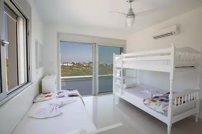 a white bedroom with a bunk bed and a window at Villa Protara Chrysos - Beautiful 5 Bedroom Protaras Villa - Walking Distance in Protaras