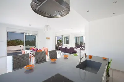 a living room with a kitchen and a dining room at Villa Protara Chrysos - Beautiful 5 Bedroom Protaras Villa - Walking Distance in Protaras