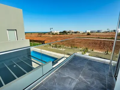a view from the balcony of a house with a swimming pool at Villa Manta Chrysos - Brand New Luxury 3 Bedroom Protaras Villa in Protaras