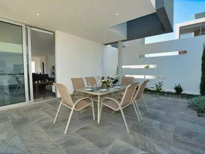 a dining room with a table and chairs at Villa Manta Chrysos - Brand New Luxury 3 Bedroom Protaras Villa in Protaras