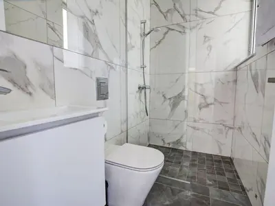 a white bathroom with a toilet and a shower at Villa Manta Chrysos - Brand New Luxury 3 Bedroom Protaras Villa in Protaras