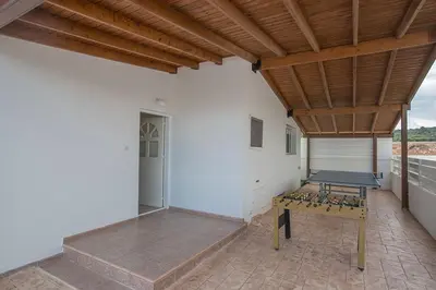 a patio with a table and a wooden ceiling at Villa Kavo Sunshine - Beautiful 3 Bedroom Protaras Villa With Private Pool in Protaras