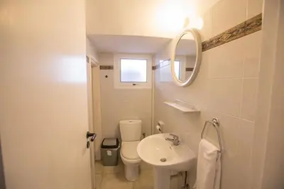 a bathroom with a sink and a toilet and a mirror at Villa Kavo Sunshine - Beautiful 3 Bedroom Protaras Villa With Private Pool in Protaras
