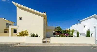 a white house with a fence in front of it at Villa Dafnis Helios - Lovely 3 Bedroom Central Protaras Villa With Pool in Protaras