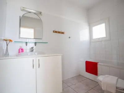 a white bathroom with a sink and a tub at Villa Lefko Sunshine - Lovely 4 Bedroom Protaras Villa With Pool in Protaras
