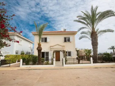 a white house with two palm trees in front of it at Villa Lefko Sunshine - Lovely 4 Bedroom Protaras Villa With Pool in Protaras