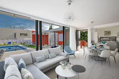 a living room with a white couch and a pool at Villa Apomono - New Luxury 3 Bedroom Protaras Villa With Pool in Protaras