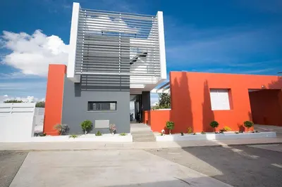 a building with an orange and white building at Villa Apomono - New Luxury 3 Bedroom Protaras Villa With Pool in Protaras