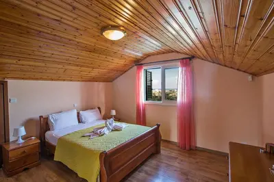a bedroom with a bed with a wooden ceiling at Villa Matronas Titan - Stunning 5 Bedroom Protaras Villa With Private Pool in Paralimni