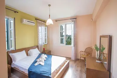 a bedroom with a bed and a table and a mirror at Villa Matronas Titan - Stunning 5 Bedroom Protaras Villa With Private Pool in Paralimni