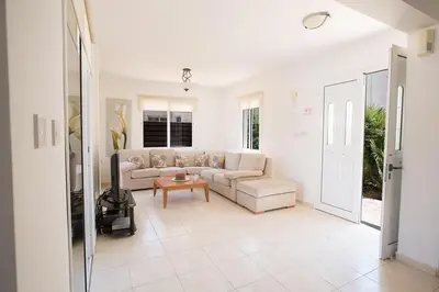 a living room with a couch and a table at Villa Protaras Eos, Modern 3Bdr Protaras Villa With Pool, Short Walk in Protaras