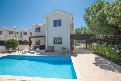 a villa with a swimming pool in front of a house at Villa Protaras Eos, Modern 3Bdr Protaras Villa With Pool, Short Walk in Protaras