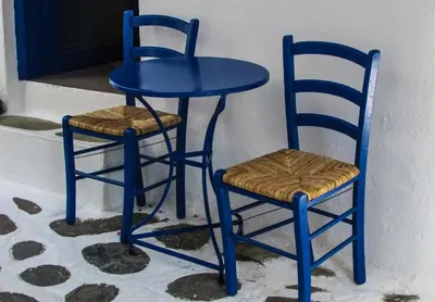 a blue table and two chairs next to a door at Villa Mesogi, Modern 3Bdr Protaras Villa, Close To Fig Tree Bay Beach in Protaras