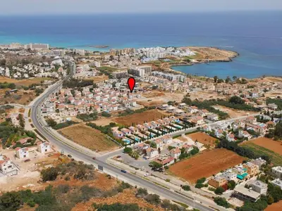 a red kite flying over a city with a road at Villa Mesogi, Modern 3Bdr Protaras Villa, Close To Fig Tree Bay Beach in Protaras