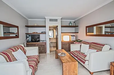 a living room with two couches and a coffee table at Villa Fig Tree Bay Seafront, Luxury 5Bdr Seafront Protaras in Protaras