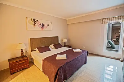 a bedroom with a large bed and a window at Villa Fig Tree Bay Seafront, Luxury 5Bdr Seafront Protaras in Protaras