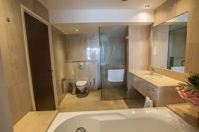 a bathroom with a tub and a toilet and a sink at Villa Fig Tree Bay Seafront, Luxury 5Bdr Seafront Protaras in Protaras