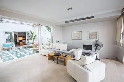 a living room with a couch and a table at Villa Fig Tree Bay Seafront, Luxury 5Bdr Seafront Protaras in Protaras