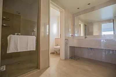 a bathroom with a shower and a sink and a toilet at Villa Fig Tree Bay Seafront, Luxury 5Bdr Seafront Protaras in Protaras