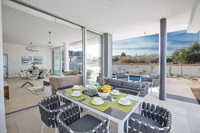 a dining room with a table and chairs at Villa Olive Thalassa, Brand New, Luxury 3Bdr Protaras Villa With Private Pool in Protaras