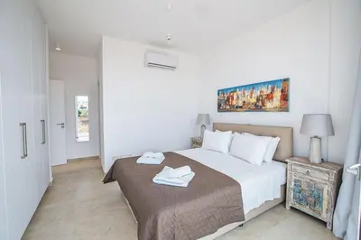a bedroom with a bed with two towels on it at Villa Olive Thalassa, Brand New, Luxury 3Bdr Protaras Villa With Private Pool in Protaras