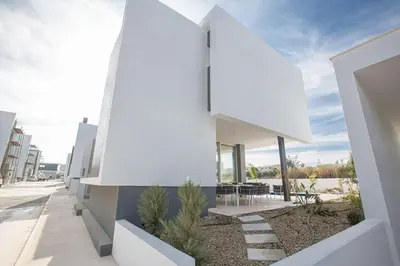a white house with a view of the street at Villa Olive Thalassa, Brand New, Luxury 3Bdr Protaras Villa With Private Pool in Protaras