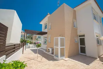 a house with a patio in front of it at Villa Dafnis Chrysos - Modern 3 Bedroom Protaras Villa With Pool in Protaras