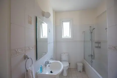 a bathroom with a sink and a toilet and a shower at Villa Dafnis Chrysos - Modern 3 Bedroom Protaras Villa With Pool in Protaras