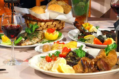 a table with plates of food and glasses of wine at Villa Olive Sun, Beautiful, Contemporary 3Bdr Villa With Private Pool in Protaras